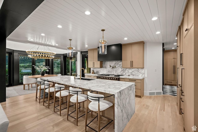 1643 E Box Elder Dr, Alpine, UT 84004 - kitchen with wall chimney exhaust hood, recessed lighting, light wood finished floors, a spacious island, and backsplash