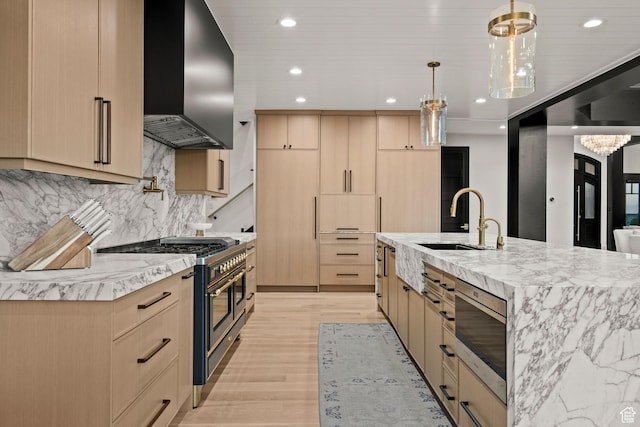 1643 E Box Elder Dr, Alpine, UT 84004 - kitchen with light brown cabinetry, wall chimney range hood, range with two ovens, recessed lighting, and stainless steel microwave