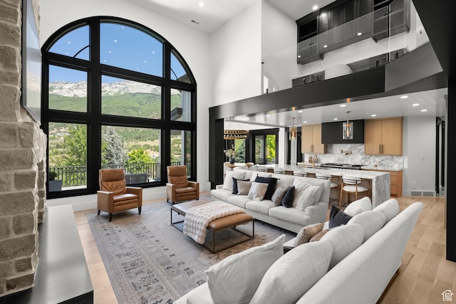 1643 E Box Elder Dr, Alpine, UT 84004 - living area featuring light wood finished floors, recessed lighting, plenty of natural light, and a towering ceiling