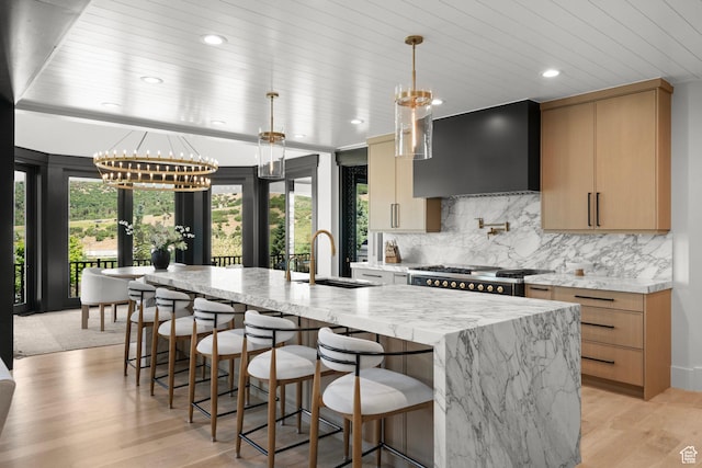 1643 E Box Elder Dr, Alpine, UT 84004 - kitchen with wall chimney range hood, plenty of natural light, a chandelier, a large island with sink, and wood ceiling
