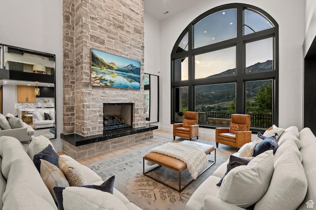 1643 E Box Elder Dr, Alpine, UT 84004 - living area featuring a towering ceiling, a stone fireplace, wood finished floors, and recessed lighting