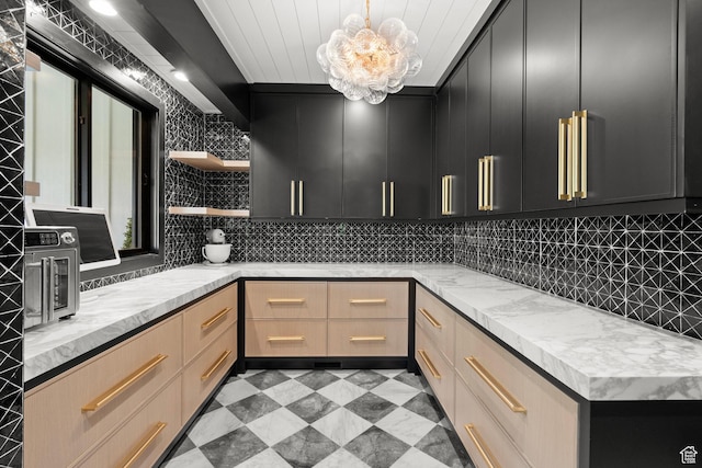 1643 E Box Elder Dr, Alpine, UT 84004 - kitchen with open shelves, dark cabinetry, decorative backsplash, and a chandelier
