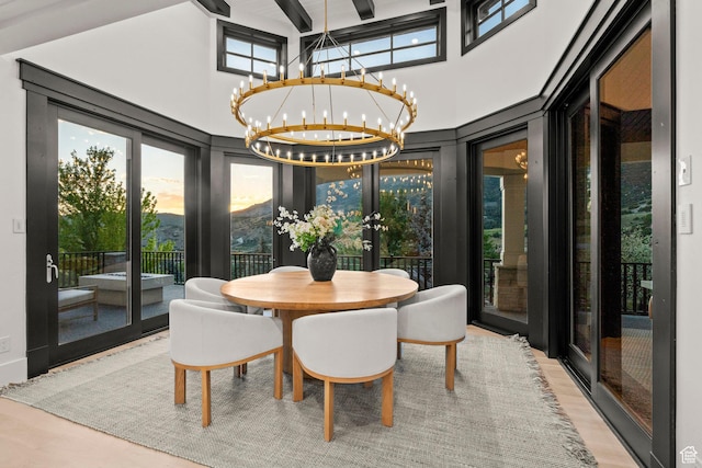 1643 E Box Elder Dr, Alpine, UT 84004 - dining space featuring a chandelier, french doors, high vaulted ceiling, and wood finished floors