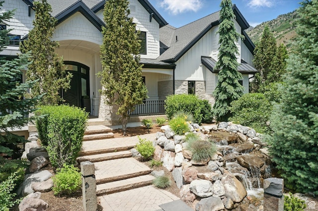 1643 E Box Elder Dr, Alpine, UT 84004 - view of front of home featuring stone siding, a porch, a standing seam roof, a shingled roof, and board and batten siding
