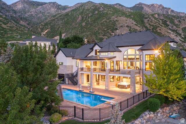 1643 E Box Elder Dr, Alpine, UT 84004 - back of house with stairs, a fenced backyard, stucco siding, a patio area, and a mountain view