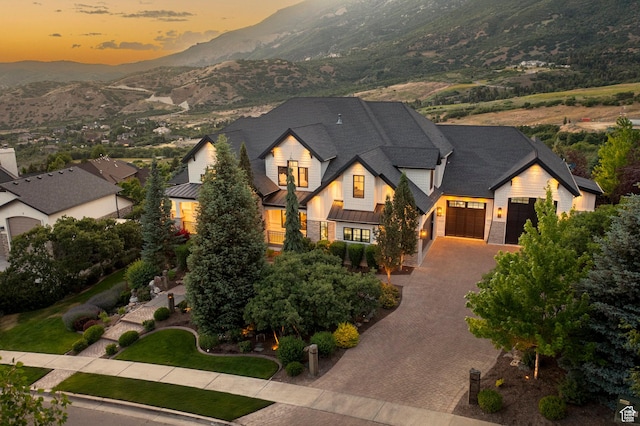 1643 E Box Elder Dr, Alpine, UT 84004 - view of front facade with an attached garage, a standing seam roof, a mountain view, decorative driveway, and a metal roof