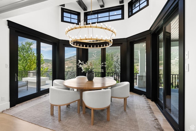 1643 E Box Elder Dr, Alpine, UT 84004 - dining area featuring french doors, wood finished floors, beamed ceiling, a chandelier, and a towering ceiling