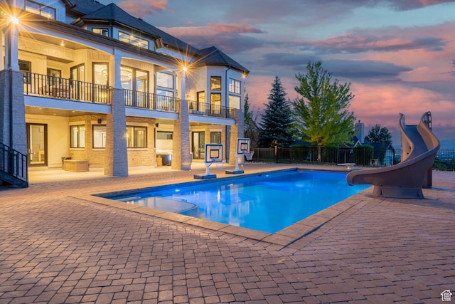 1643 E Box Elder Dr, Alpine, UT 84004 - view of pool with a water slide, a patio area, and a pool with connected hot tub