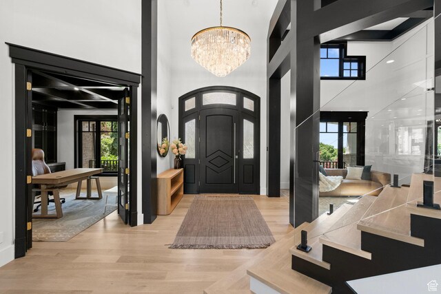 1643 E Box Elder Dr, Alpine, UT 84004 - foyer entrance featuring a chandelier, a towering ceiling, light wood-style floors, and healthy amount of natural light