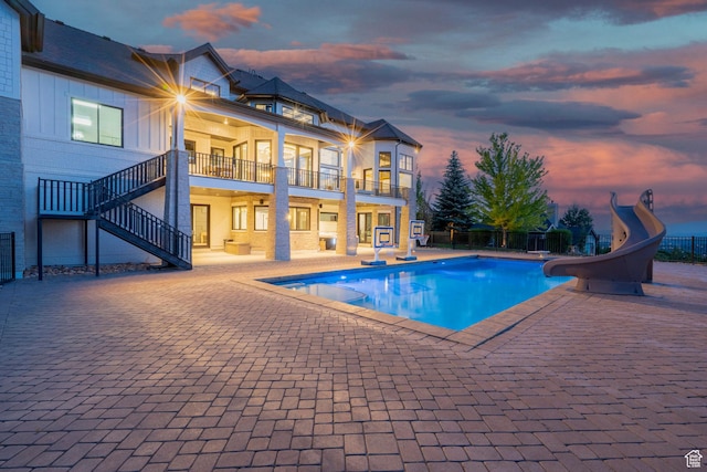 1643 E Box Elder Dr, Alpine, UT 84004 - pool at dusk with a water slide, a patio area, and stairs