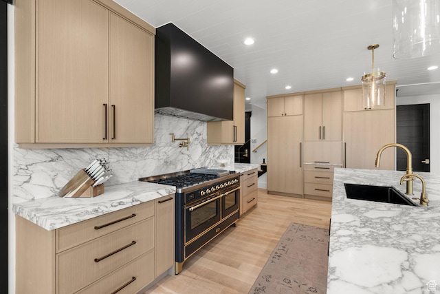 1643 E Box Elder Dr, Alpine, UT 84004 - kitchen with range with two ovens, wall chimney exhaust hood, light brown cabinets, light stone counters, and backsplash