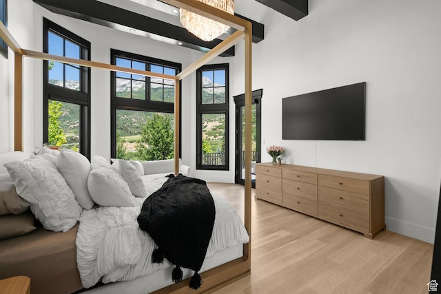 1643 E Box Elder Dr, Alpine, UT 84004 - bedroom with a towering ceiling, light wood-type flooring, and a chandelier
