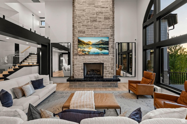 1643 E Box Elder Dr, Alpine, UT 84004 - living room with a high ceiling, a fireplace, wood finished floors, and stairway