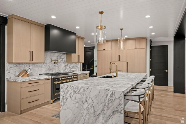 1643 E Box Elder Dr, Alpine, UT 84004 - kitchen featuring double oven range, light brown cabinets, exhaust hood, decorative backsplash, and light wood-style flooring