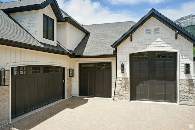 1643 E Box Elder Dr, Alpine, UT 84004 - view of front of property with roof with shingles, stone siding, decorative driveway, and a garage