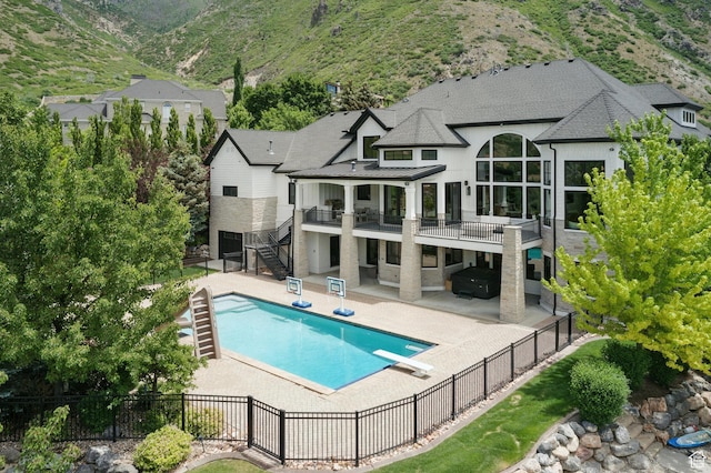 1643 E Box Elder Dr, Alpine, UT 84004 - rear view of property featuring stairs, a fenced backyard, a standing seam roof, and a patio area
