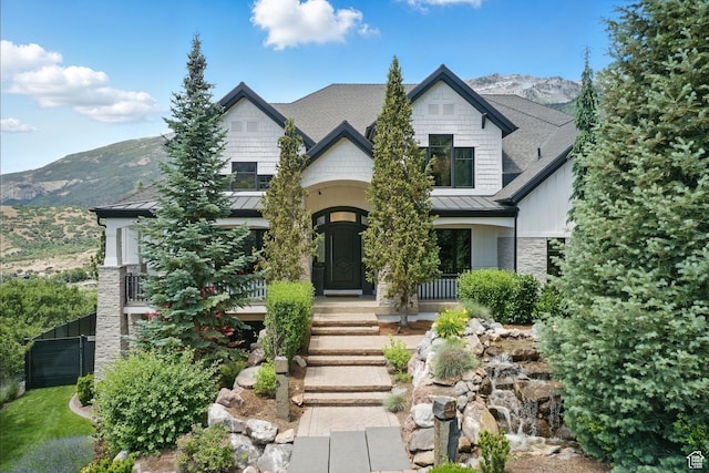 1643 E Box Elder Dr, Alpine, UT 84004 - view of front of home with a standing seam roof, stone siding, a mountain view, a metal roof, and a porch