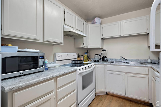 835 E 500 N, Spanish Fork, UT 84660 - kitchen featuring electric stove, stainless steel microwave, under cabinet range hood, light countertops, and light wood-style flooring