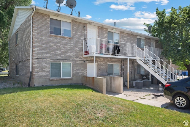 835 E 500 N, Spanish Fork, UT 84660 - rear view of house with a yard, a patio, and brick siding