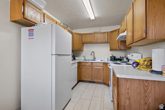 835 E 500 N, Spanish Fork, UT 84660 - kitchen featuring white appliances, under cabinet range hood, light countertops, and brown cabinetry