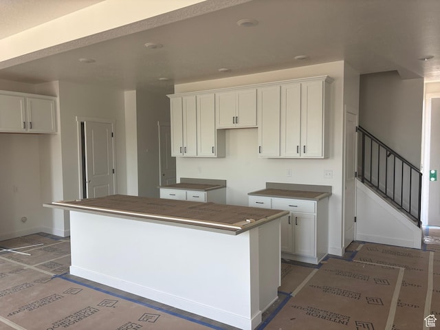 1719 W Brocious Way S Unit 301, South Jordan, UT 84095 - kitchen with a center island and white cabinetry