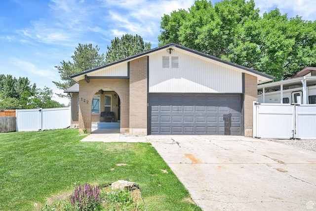 122 W 5300 S, Washington Terrace, UT 84405 - view of front facade featuring brick siding, a garage, and concrete driveway