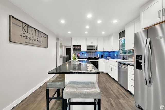 122 W 5300 S, Washington Terrace, UT 84405 - kitchen with stainless steel appliances, decorative backsplash, dark wood-style flooring, a center island, and white cabinetry