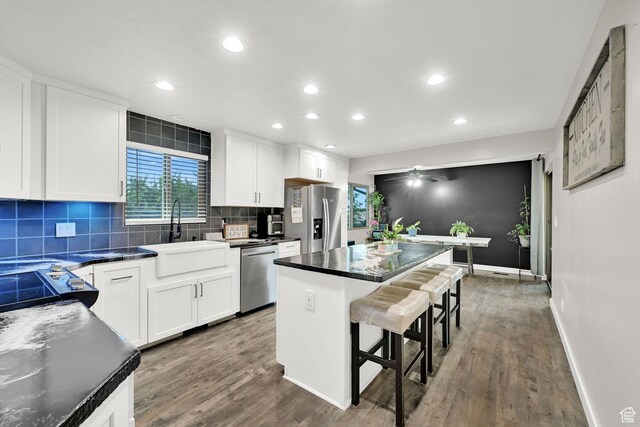 122 W 5300 S, Washington Terrace, UT 84405 - kitchen featuring stainless steel appliances, a breakfast bar area, dark wood-type flooring, a kitchen island, and recessed lighting