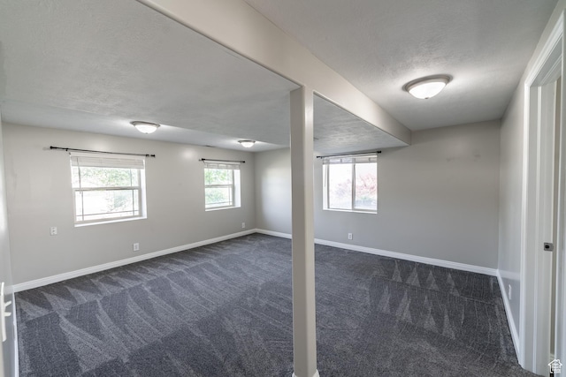 271 E Eagle Ridge Dr, North Salt Lake, UT 84054 - below grade area featuring dark colored carpet and a textured ceiling
