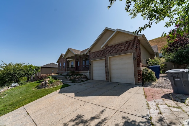 271 E Eagle Ridge Dr, North Salt Lake, UT 84054 - view of front of home featuring brick siding, a garage, a front yard, and driveway