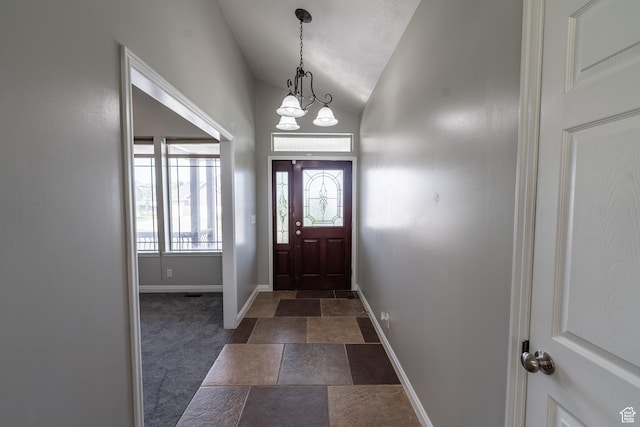 271 E Eagle Ridge Dr, North Salt Lake, UT 84054 - entrance foyer with vaulted ceiling, dark carpet, and dark stone finish flooring