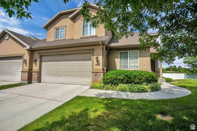 1017 E 450 N Cir N, American Fork, UT 84003 - view of front facade featuring stucco siding, driveway, an attached garage, and brick siding