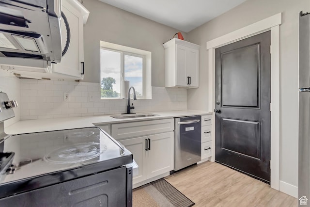 2743 Grant Ave Unit 2B, Ogden, UT 84401 - kitchen featuring stainless steel dishwasher, white microwave, electric range, white cabinetry, and backsplash