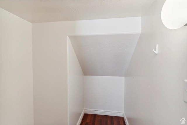 3119 N Whitetail Dr Unit 85, Layton, UT 84040 - bonus room featuring dark wood-style flooring, a textured ceiling, and vaulted ceiling