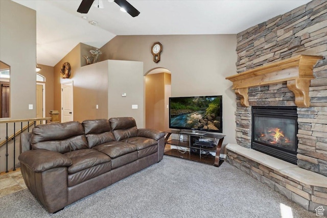 3146 N 750 W, Pleasant View, UT 84414 - living room featuring ceiling fan, carpet, a fireplace, vaulted ceiling, and arched walkways