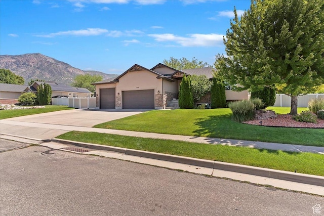 3146 N 750 W, Pleasant View, UT 84414 - view of front of house featuring stucco siding, an attached garage, driveway, a mountain view, and stone siding