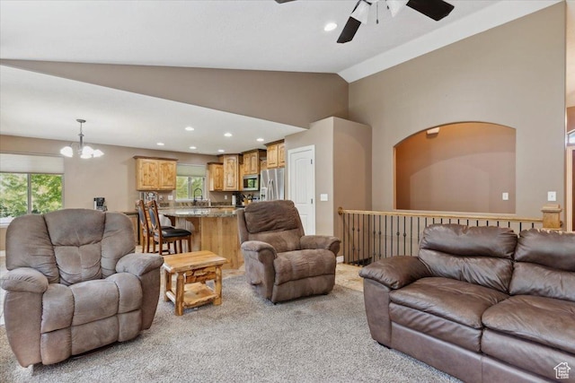 3146 N 750 W, Pleasant View, UT 84414 - living area with a ceiling fan, light colored carpet, vaulted ceiling, a chandelier, and plenty of natural light