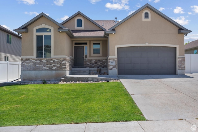 6097 W Cedar Hill Rd S, West Jordan, UT 84081 - view of front facade featuring stucco siding, an attached garage, driveway, and stone siding