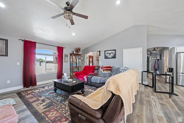 3712 N 250 E, Enoch, UT 84721 - living room with a ceiling fan, vaulted ceiling, arched walkways, light wood-type flooring, and recessed lighting