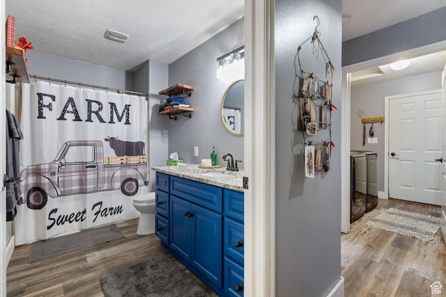 3712 N 250 E, Enoch, UT 84721 - bathroom featuring independent washer and dryer, wood finished floors, vanity, a textured ceiling, and a shower with curtain