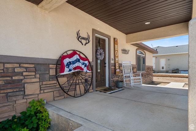 3712 N 250 E, Enoch, UT 84721 - doorway to property featuring stone siding, stucco siding, and a porch