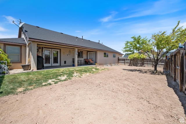 3712 N 250 E, Enoch, UT 84721 - back of house with a fenced backyard, a patio, a shingled roof, french doors, and stucco siding
