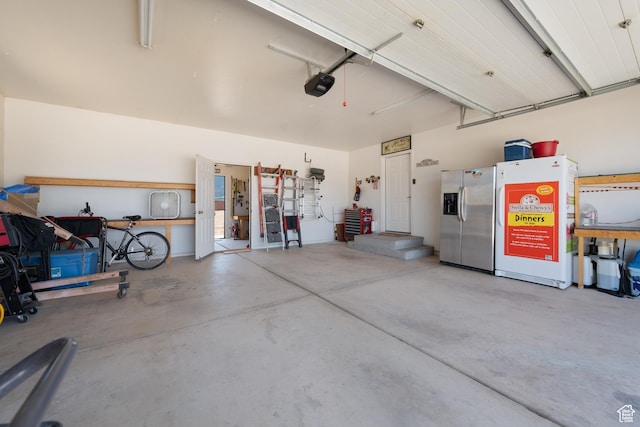 3712 N 250 E, Enoch, UT 84721 - garage with stainless steel fridge with ice dispenser and a garage door opener