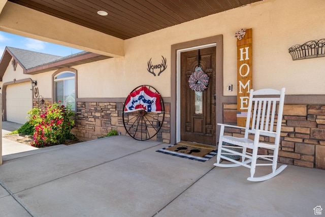 3712 N 250 E, Enoch, UT 84721 - property entrance with stucco siding, stone siding, and a garage