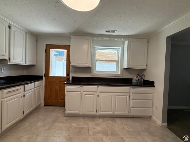 1885 S 50 W, Bountiful, UT 84010 - kitchen with white cabinetry, dark countertops, ornamental molding, and a textured ceiling
