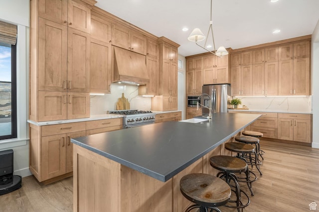 330 N Haystack Mountain Dr, Heber City, UT 84032 - kitchen featuring stainless steel appliances, premium range hood, light wood finished floors, backsplash, and a kitchen bar