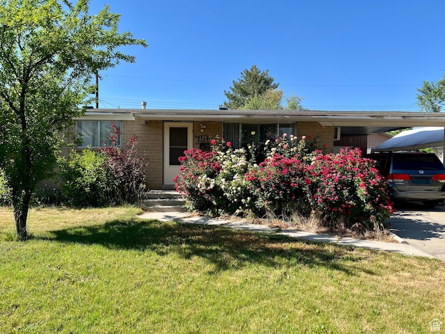 125 E 6940 S, Midvale, UT 84047 - single story home featuring brick siding, a front yard, and a carport