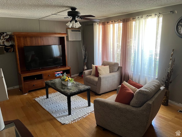 125 E 6940 S, Midvale, UT 84047 - living room with plenty of natural light, an AC wall unit, ceiling fan, wood finished floors, and a textured ceiling