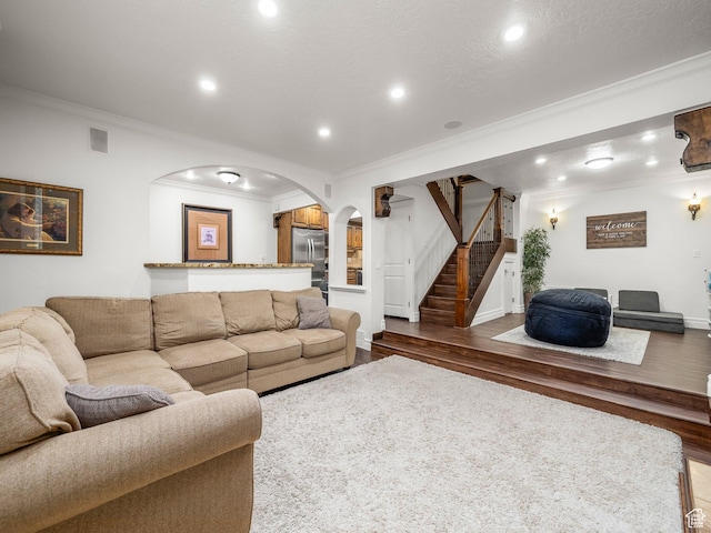 3228 N Brook Ln W, Provo, UT 84604 - living room with crown molding, arched walkways, wood finished floors, stairway, and recessed lighting