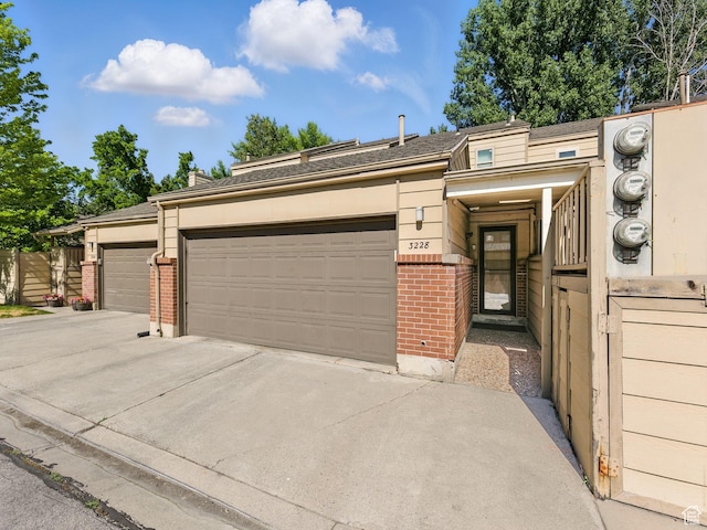 3228 N Brook Ln W, Provo, UT 84604 - view of front facade with brick siding, a garage, and driveway
